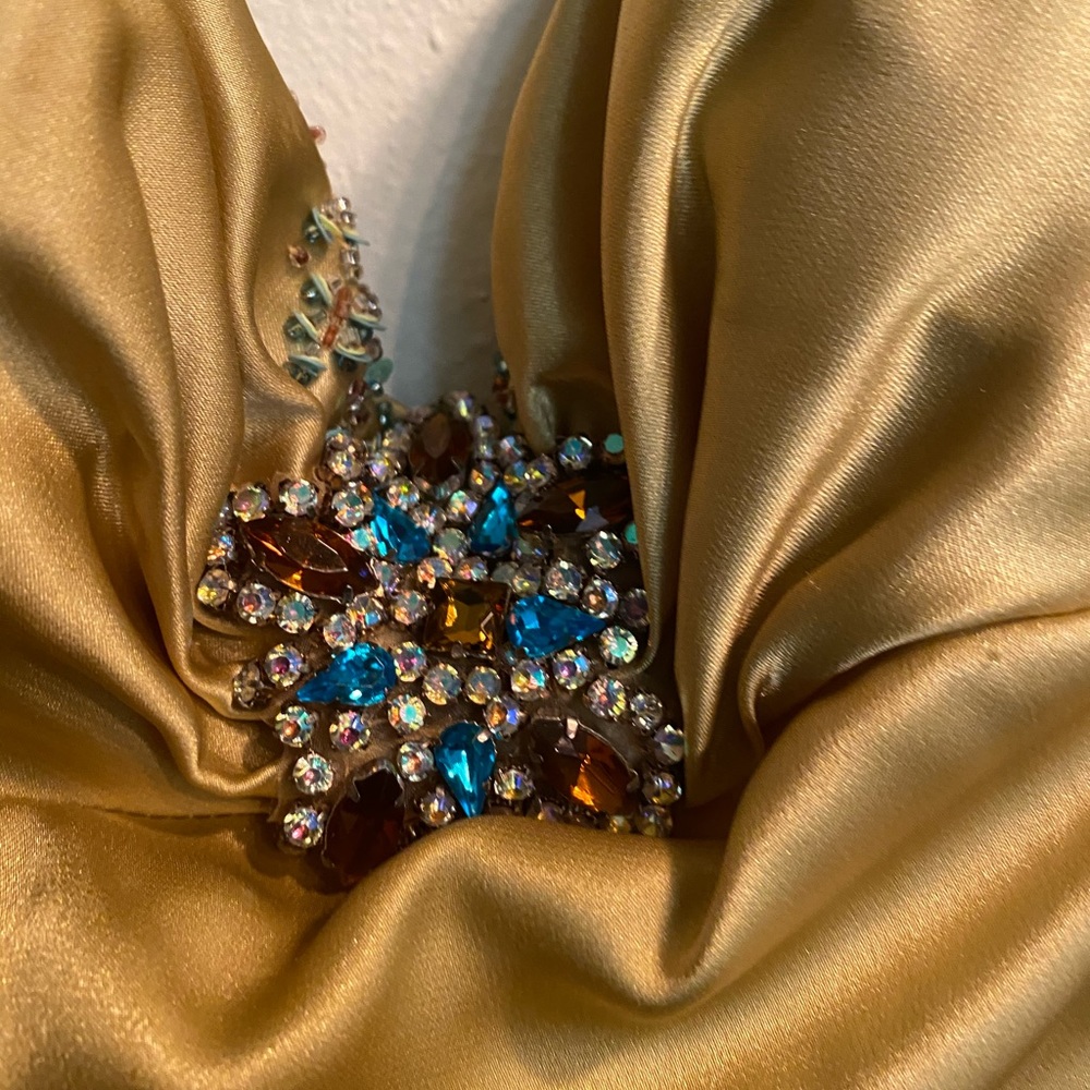 Beautiful backless jeweled gold formal gown.